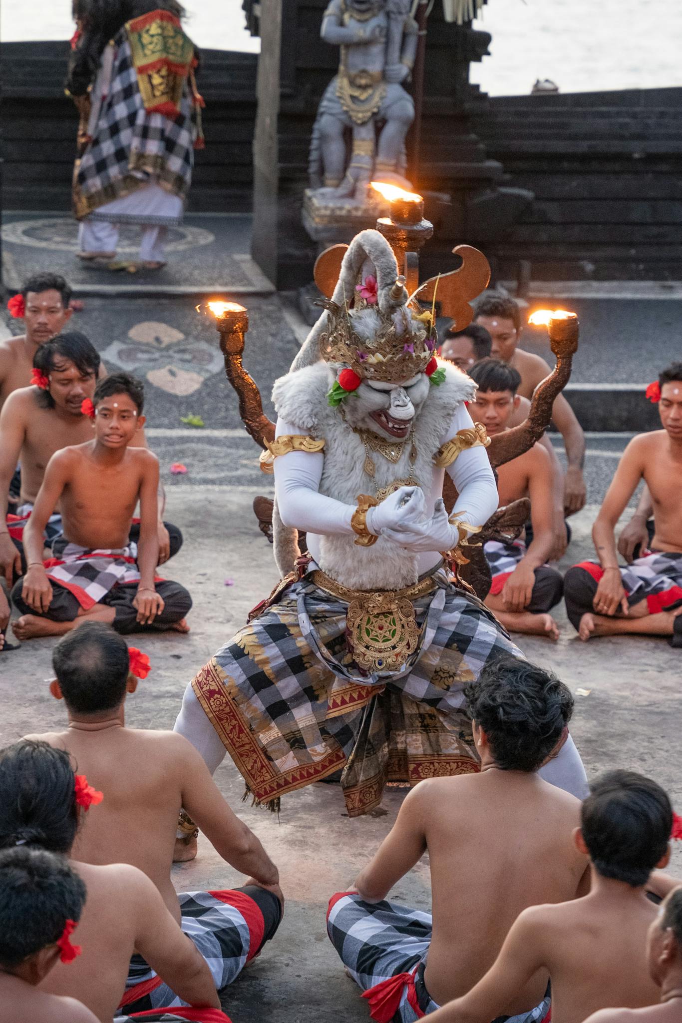 A vibrant traditional Kecak dance performed outdoors in Bali with dancers in cultural attire.