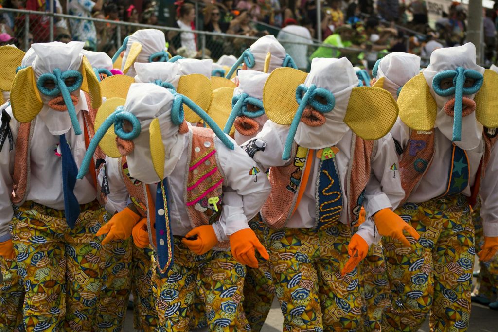 Vibrant costumes and masks at the Barranquilla Carnival parade, a lively cultural celebration in Colombia.
