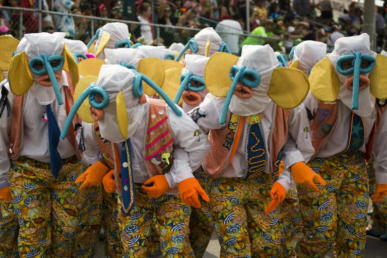 Vibrant costumes and masks at the Barranquilla Carnival parade, a lively cultural celebration in Colombia.