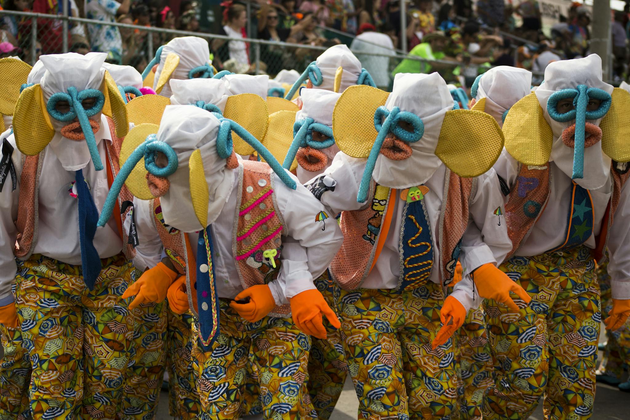 Vibrant costumes and masks at the Barranquilla Carnival parade, a lively cultural celebration in Colombia.